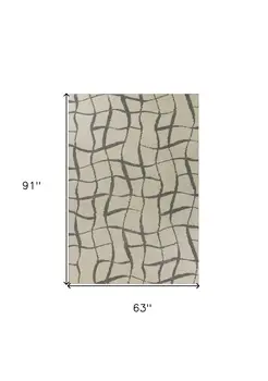 5' X 7' Ivory Machine Woven Abstract Indoor Shag Rug
