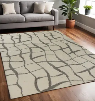 5' X 7' Ivory Machine Woven Abstract Indoor Shag Rug