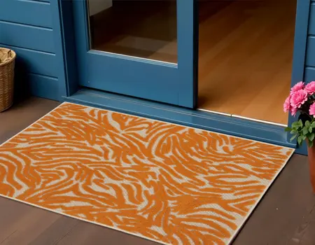 3' X 4' Orange And Ivory Abstract Indoor Outdoor Area Rug