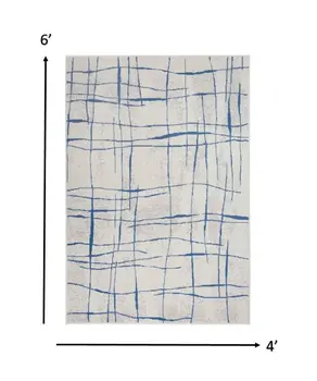 4' X 6' Ivory And Blue Geometric Distressed Area Rug