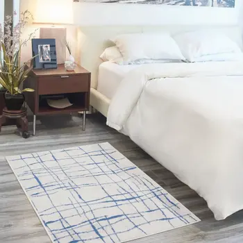 5' X 7' Ivory And Blue Geometric Distressed Area Rug