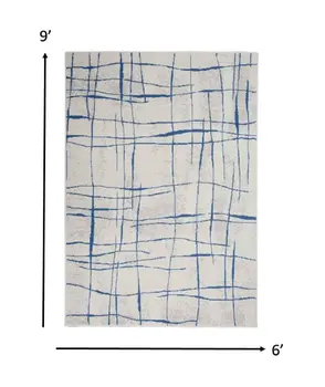 6' X 9' Ivory And Blue Geometric Distressed Area Rug