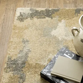 5' X 8' Beige Grey And Gold Abstract Power Loom Stain Resistant Area Rug