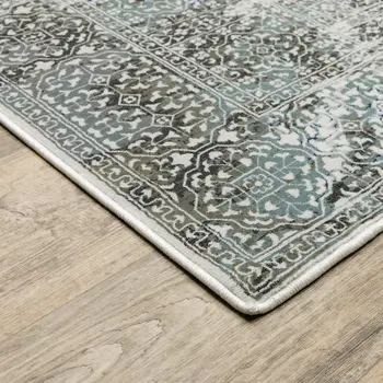 6' X 9' Ivory Grey Charcoal Blue And Rust Oriental Power Loom Stain Resistant Area Rug
