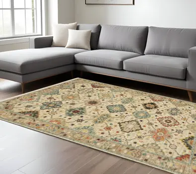6' X 9' Beige Pale Blue Rust Gold Tan Brown And Orange Oriental Power Loom Stain Resistant Area Rug With Fringe