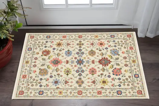 3' X 5' Ivory Salmon Pink Gold Blues Grey Rust And Green Oriental Power Loom Stain Resistant Area Rug With Fringe