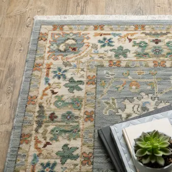 5' X 8' Blue And Ivory Oriental Power Loom Stain Resistant Area Rug With Fringe