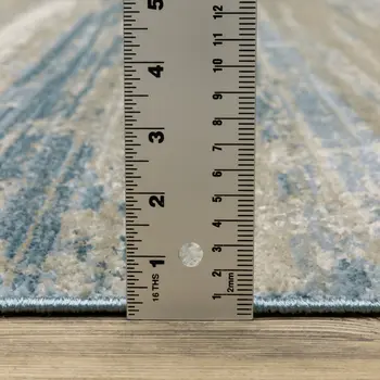 10' X 13' Ivory Beige Grey Blue And Tan Abstract Power Loom Stain Resistant Area Rug With Fringe