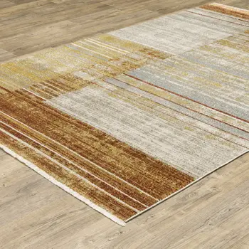 5' X 8' Rust Gold Blue Grey Ivory And Tan Geometric Power Loom Stain Resistant Area Rug With Fringe
