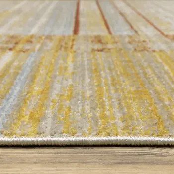 5' X 8' Rust Gold Blue Grey Ivory And Tan Geometric Power Loom Stain Resistant Area Rug With Fringe