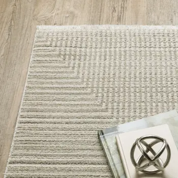 10' X 13' Ivory Beige Taupe And Tan Geometric Power Loom Stain Resistant Area Rug With Fringe