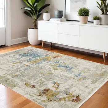 4' X 6' Beige Grey Gold Blue Rust And Teal Abstract Power Loom Stain Resistant Area Rug With Fringe