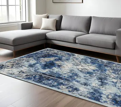 10' X 14' Blue Ivory And Gray Floral Distressed Stain Resistant Area Rug