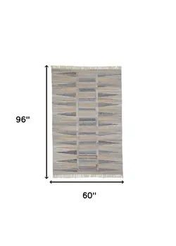 5' X 8' Tan Gray And Taupe Geometric Hand Woven Stain Resistant Area Rug With Fringe