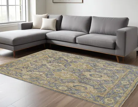 8' X 10' Blue Gold And Tan Wool Floral Hand Knotted Stain Resistant Area Rug With Fringe