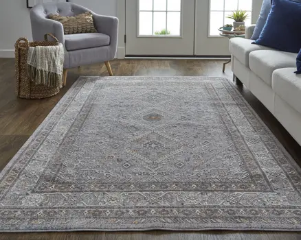 10' X 13' Gray Orange And Ivory Floral Power Loom Stain Resistant Area Rug