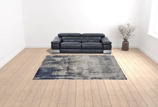 9' X 12' Tan Blue And Ivory Abstract Power Loom Distressed Area Rug