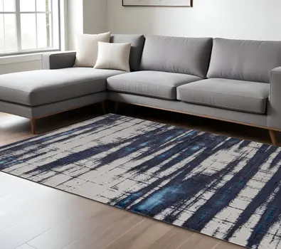 7' X 10' Ivory and Blue Abstract Power Loom Distressed Non Skid Area Rug