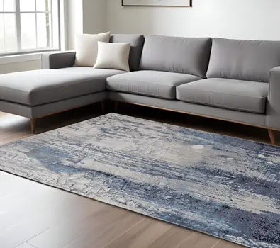 7' X 10' Ivory Blue And Black Abstract Power Loom Distressed Area Rug
