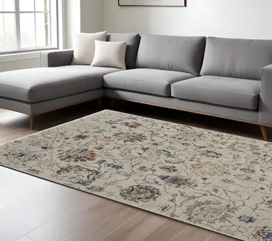 10' X 13' Ivory Orange And Blue Floral Power Loom Distressed Area Rug With Fringe
