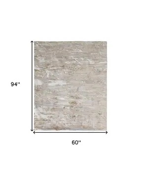 5' X 8' Tan And Ivory Abstract Power Loom Distressed Area Rug
