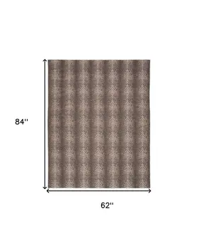 5' X 7' Brown and Ivory Leopard Print Power Loom Washable Non Skid Area Rug