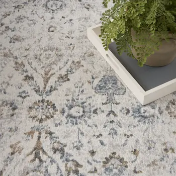 7' X 9' Blue and Ivory Floral Medallion Power Loom Distressed Washable Area Rug