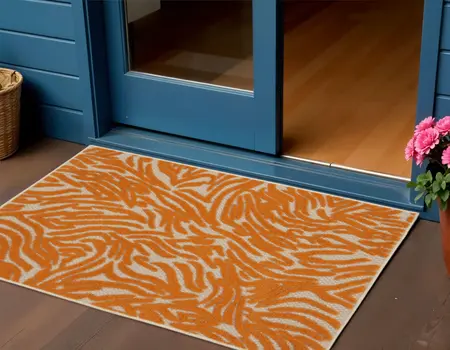 3' X 4' Orange And Ivory Animal Print Indoor Outdoor Area Rug