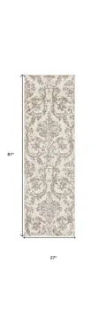 7' Beige and Ivory Damask Distressed Runner Rug