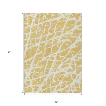 5' X 8' Gold and White Abstract Washable Non Skid Indoor Outdoor Area Rug