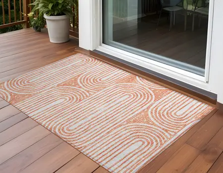2' X 3' Orange and Ivory Abstract Washable Non Skid Indoor Outdoor Area Rug