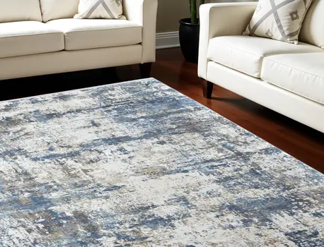 7' X 10' Ivory Tan and Blue Abstract Power Loom Area Rug With Fringe