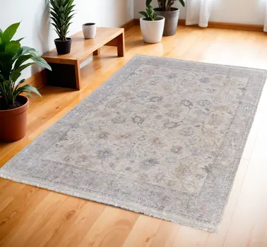 4' X 6' Ivory Tan and Blue Floral Hand Woven Distressed Area Rug With Fringe