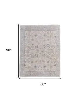 5' X 8' Ivory Tan and Blue Floral Hand Woven Distressed Area Rug With Fringe