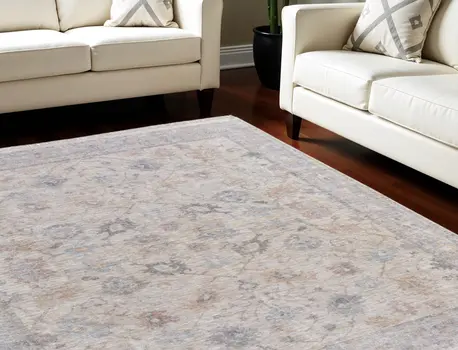 8' X 10' Ivory Tan and Blue Floral Hand Woven Distressed Area Rug With Fringe