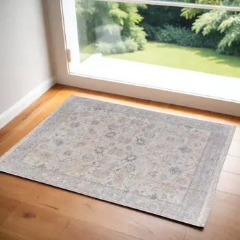 2' X 3' Ivory Tan and Blue Floral Hand Woven Distressed Area Rug With Fringe