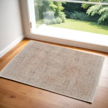2' X 3' Tan Orange and Ivory Oriental Hand Woven Distressed Area Rug With Fringe