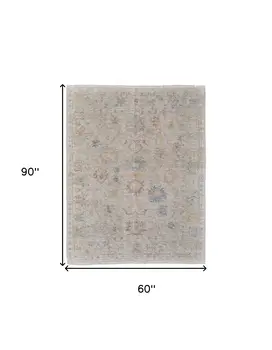 5' X 8' Tan Brown and Blue Floral Hand Woven Distressed Area Rug With Fringe