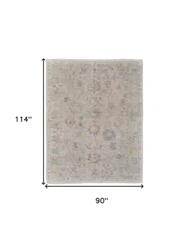 8' X 10' Tan Brown and Blue Floral Hand Woven Distressed Area Rug With Fringe