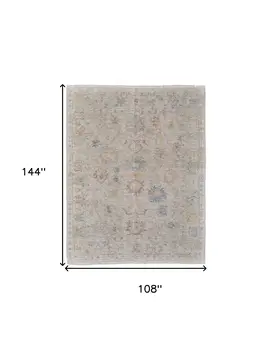 9' X 12' Tan Brown and Blue Floral Hand Woven Distressed Area Rug With Fringe