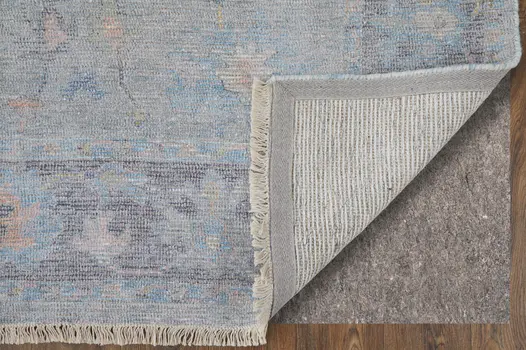 10' X 14' Orange Blue and Gold Floral Hand Woven Distressed Area Rug With Fringe