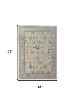 6' X 9' Gray Ivory and Blue Wool Floral Hand Knotted Area Rug With Fringe