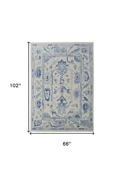 6' X 9' Ivory and Blue Wool Floral Hand Knotted Area Rug With Fringe