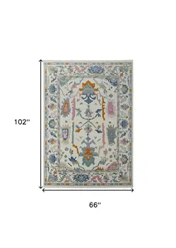 6' X 9' Blue Ivory and Pink Wool Floral Hand Knotted Area Rug With Fringe