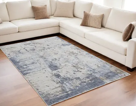 5' X 8' Ivory Gray and Blue Abstract Power Loom Worn Faded Area Rug
