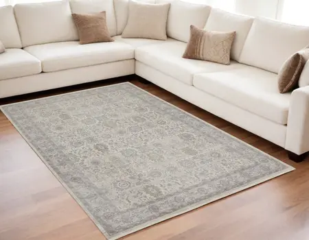 5' X 7' Gray and Ivory Oriental Power Loom Worn Faded Area Rug With Fringe
