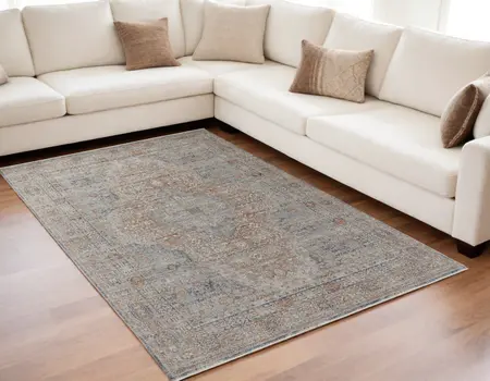 5' X 7' Gray Ivory and Orange Oriental Power Loom Worn Faded Area Rug With Fringe