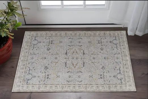 2' X 3' Ivory Taupe and Blue Ikat Power Loom Worn Faded Area Rug With Fringe