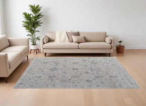 7' X 10' Ivory Taupe and Blue Floral Power Loom Worn Faded Area Rug With Fringe