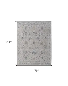 7' X 10' Ivory Taupe and Blue Floral Power Loom Worn Faded Area Rug With Fringe